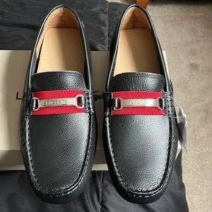 Lacoste black leather loafers.